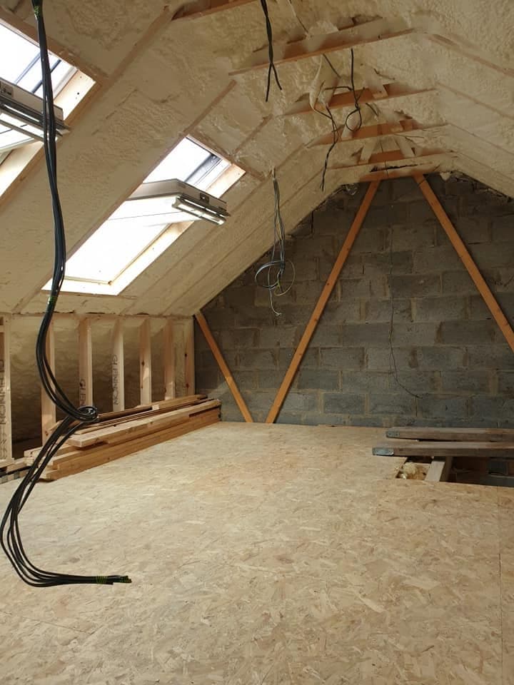 Attic insulation installed across the floor of a residential attic