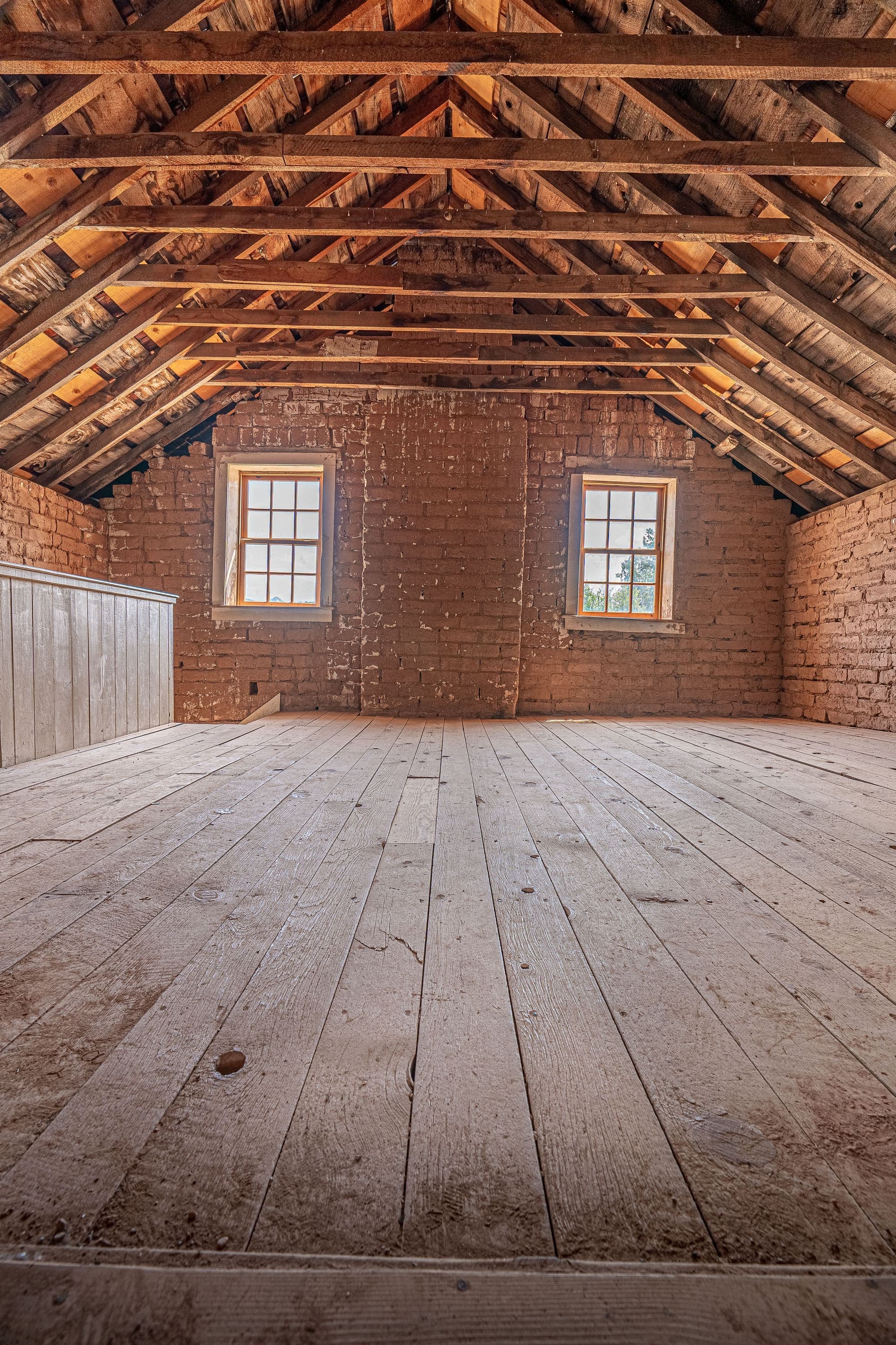 Attic insulation covering the attic floor between roof framing